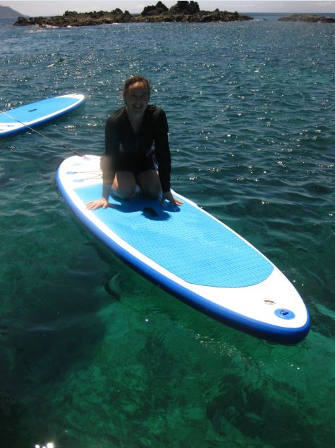 Sheryl getting comfortable on her paddle board